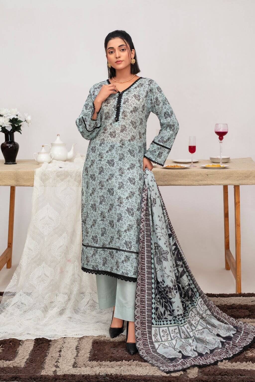 Serene Bloom summer lawn 3-piece suit with lace-accented shirt, plain dupatta, and dyed trousers. Nishaq ready to wear.